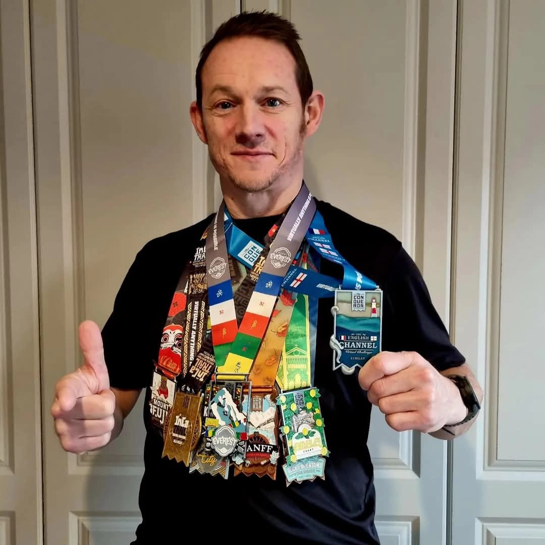 Paul Broesmith displaying the medals he earned as part of the Ancestories project